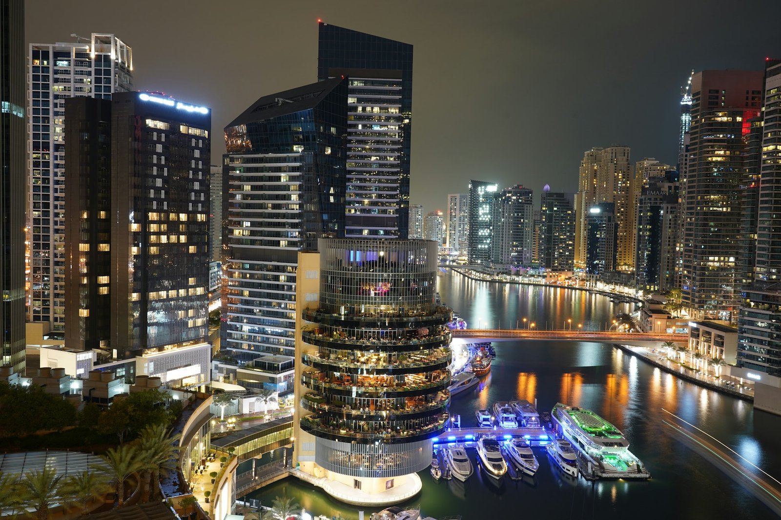 Dubai Marina towers and illuminated boats at night