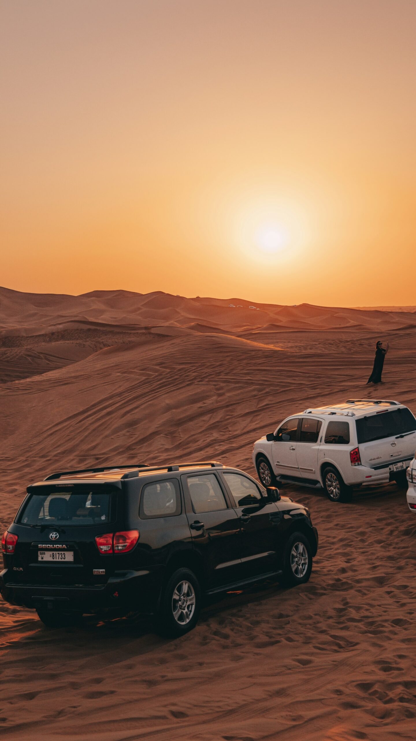 Land Cruisers on the red dunes at sunset on an evening desert safari in Dubai