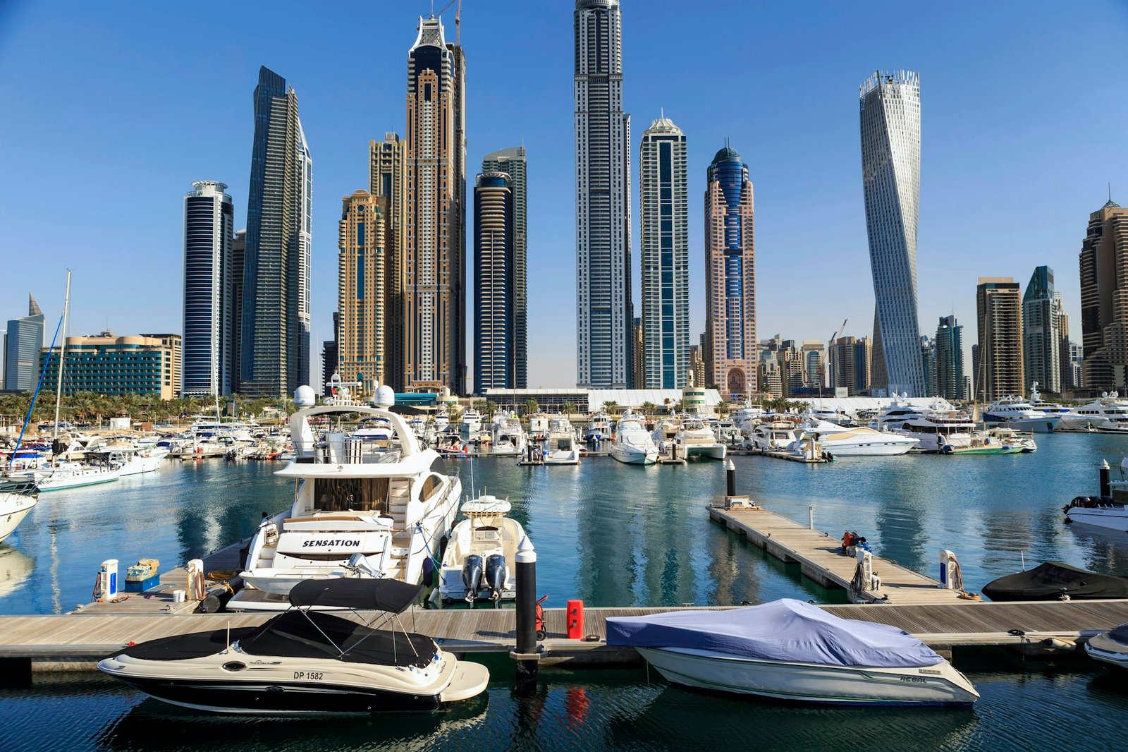 Boats and yachts in Dubai Marina with the skyline behind